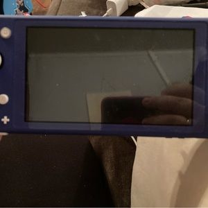 Nintendo switch light. Used once. Comes with charger and 2 Mario games